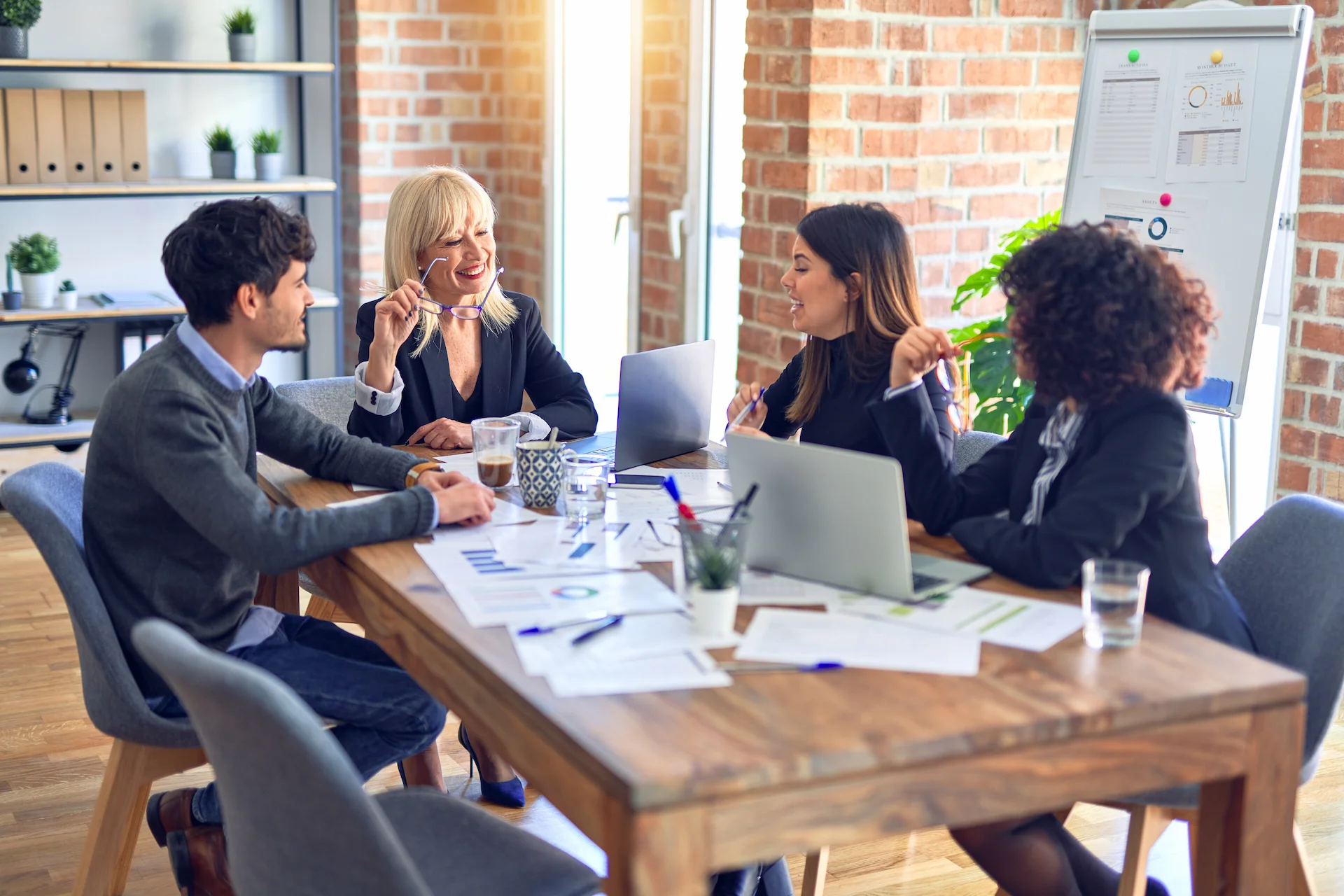 group of co-workers sitting at a conference table and discussing their commercial umbrella insurance options