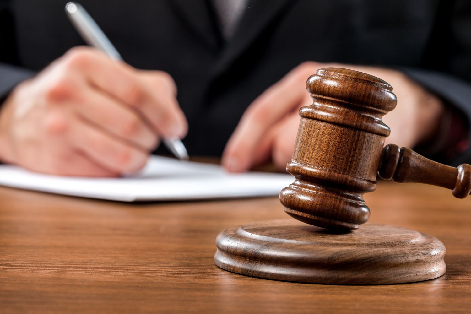 Legal symbols with insurance paperwork, reflecting legal cost coverage provided by commercial umbrella insurance in Massachusetts
