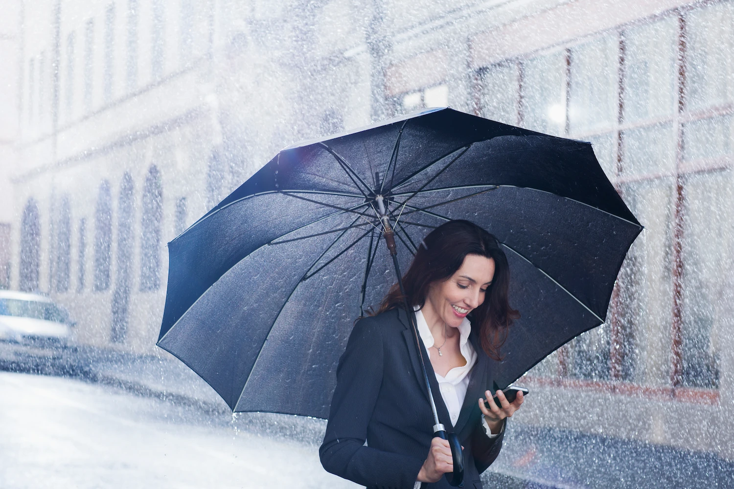 a woman holding an umbrella in the rain