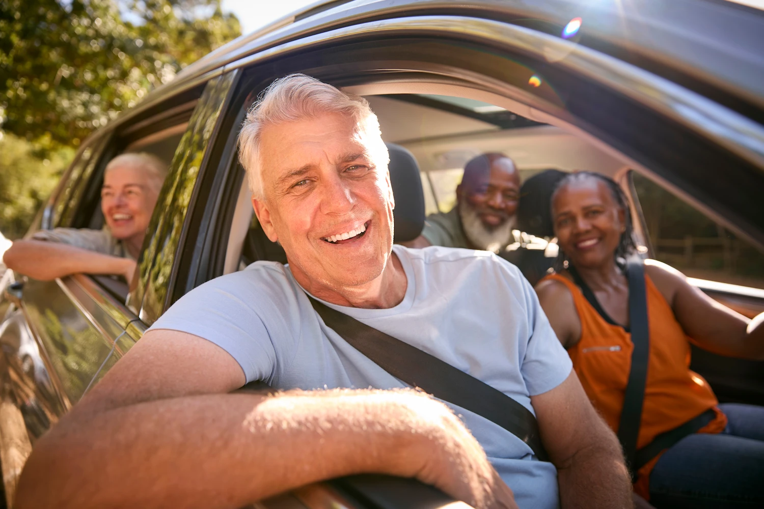 happy friends driving together in car, happy knowing they have personal auto insurance