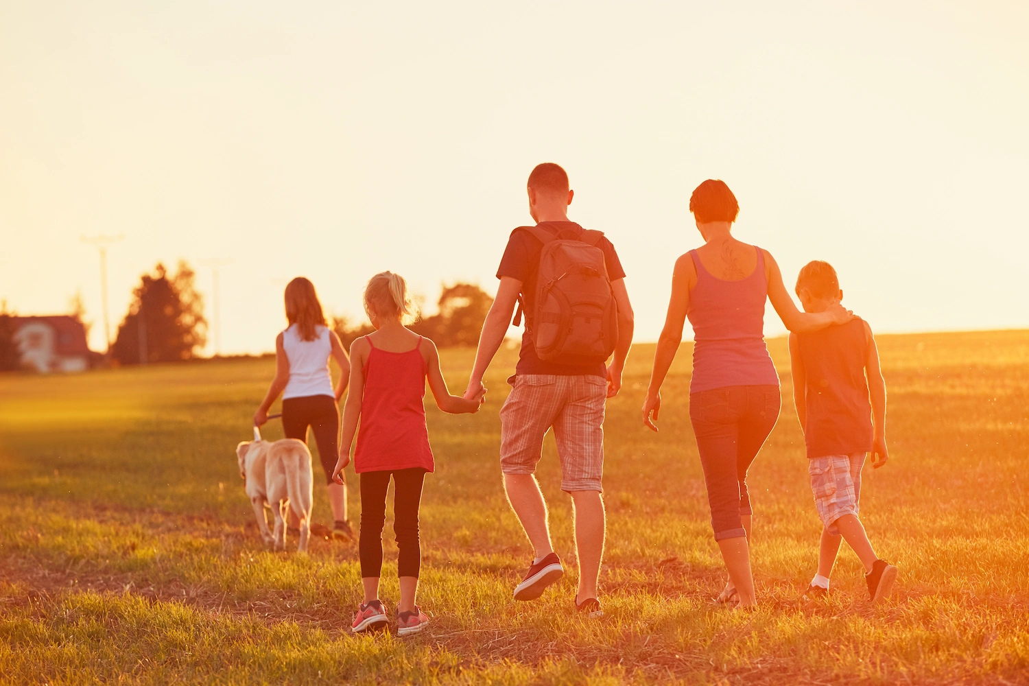 family walking through a field